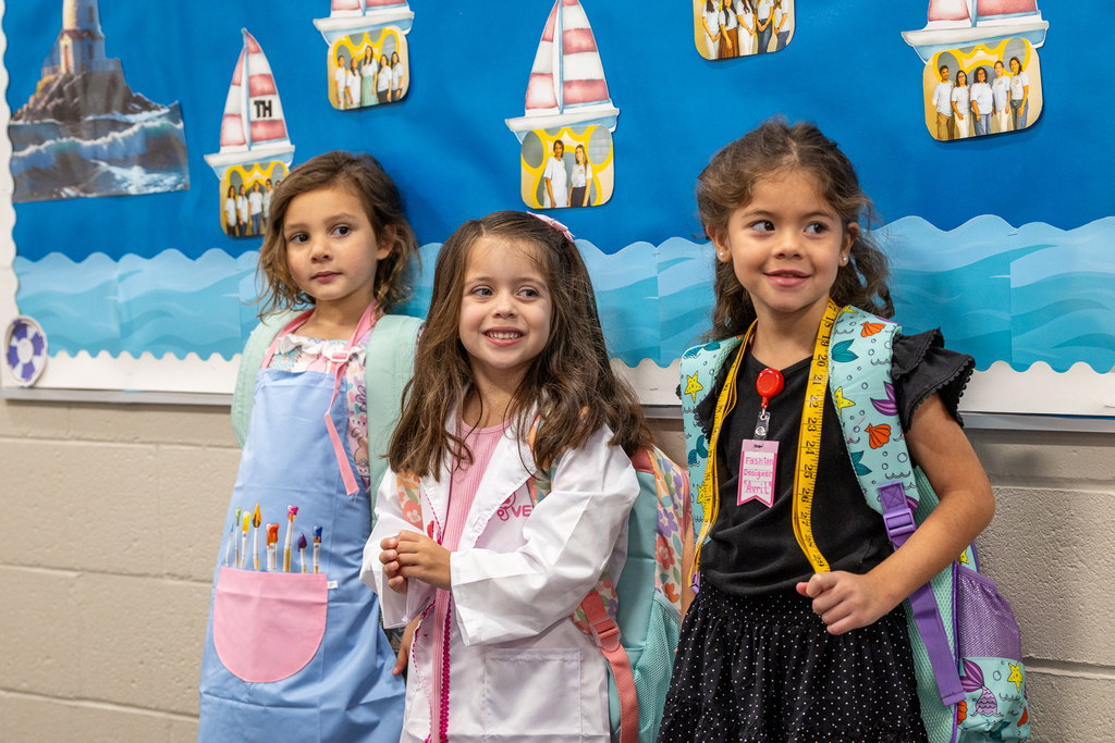 girls dressed in the uniform of a painter, a doctor and a fashion designer
