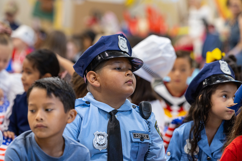boy and girl in crowd wearing police officer uniforms