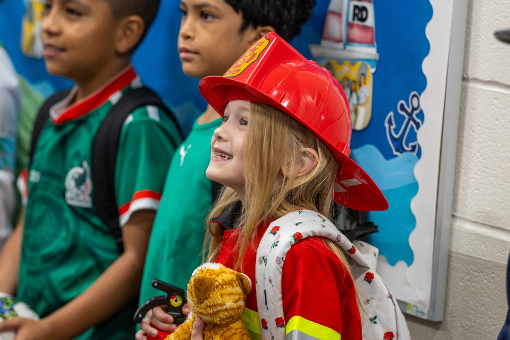 girl in firefighter uniform smiling