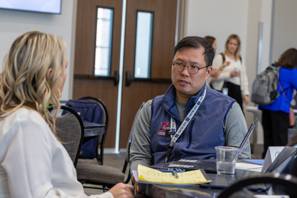 Robert Quach talking at table
