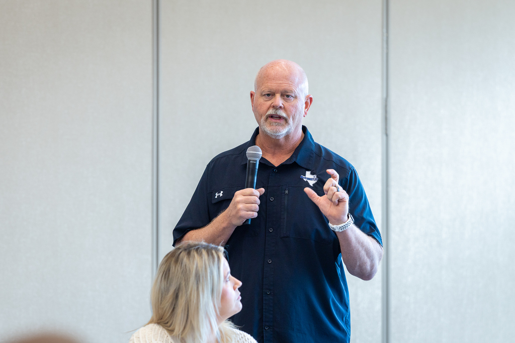 Pratt speaking with microphone