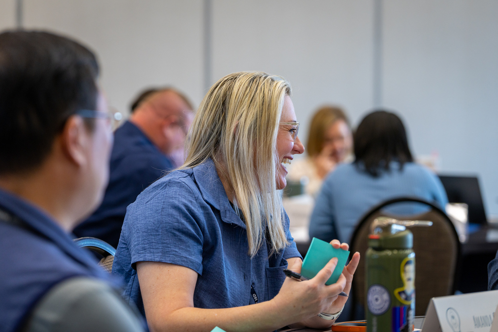 woman laughing at table