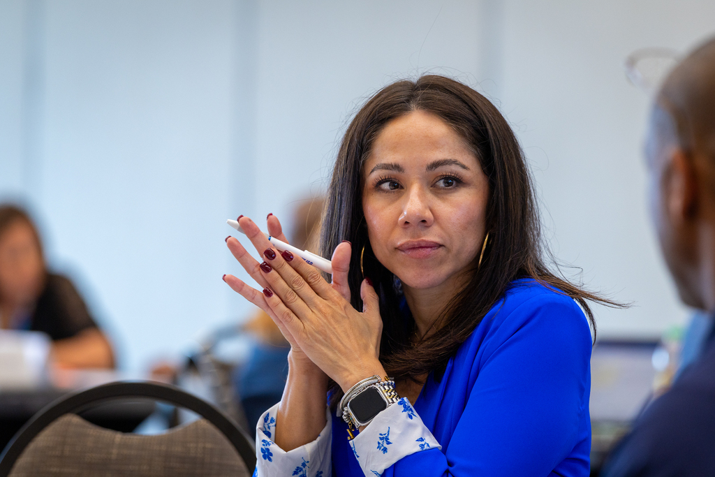 Zabdi Gonzalez listening to another leader talking during table activity