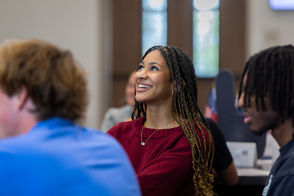 female student looking up and smiling