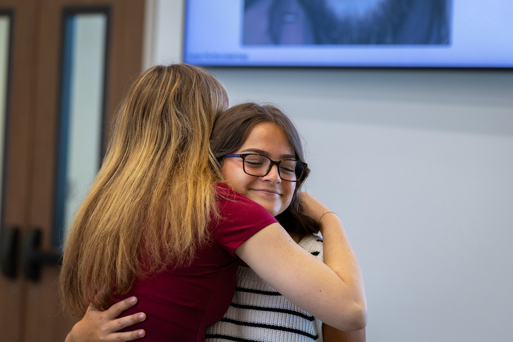two female students hugging