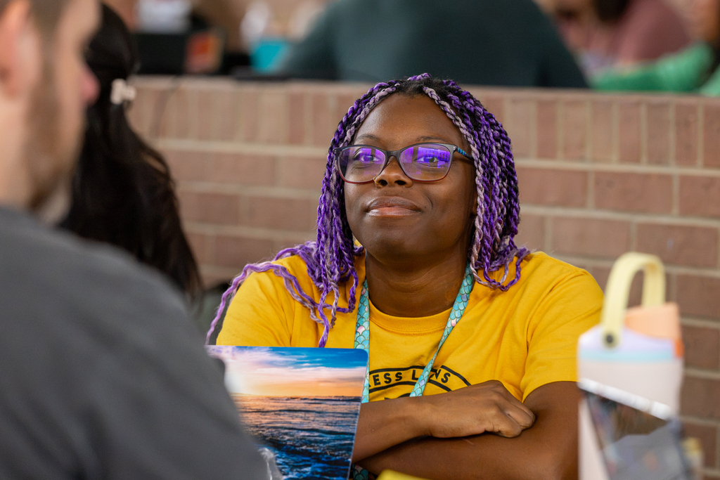 female teacher at table listening