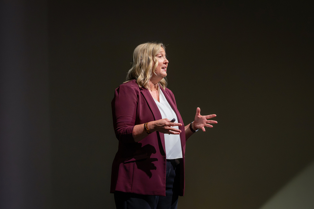 Paula Maeker speaking on stage