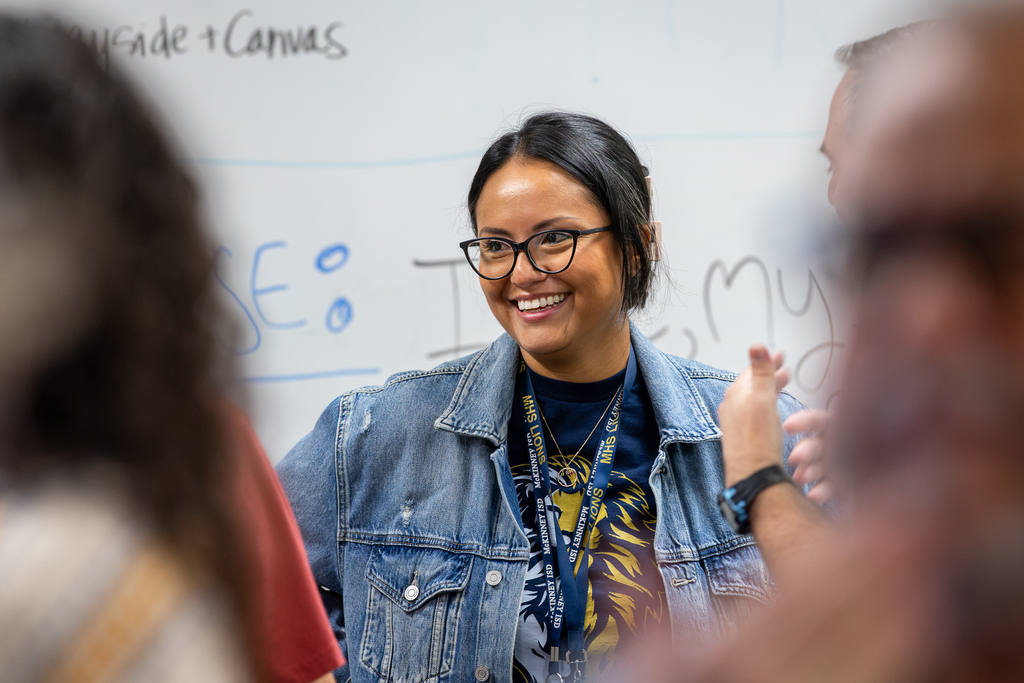 female teacher in session smiling during activity