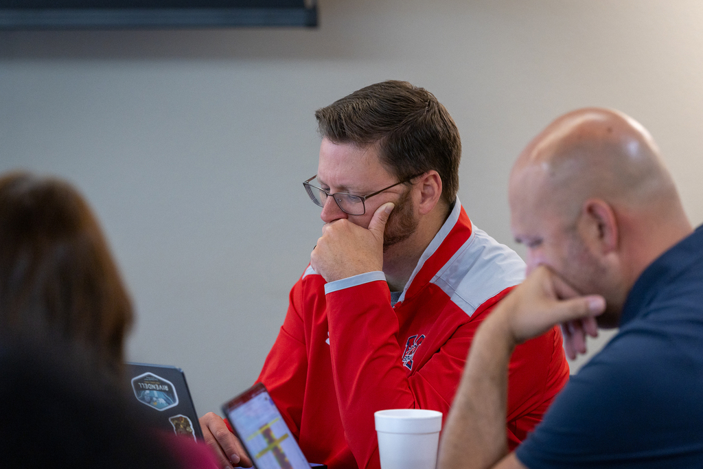 principal looking at computer thoughtfully during session