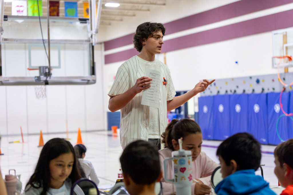 high school student leading group through a sensory simulation activity