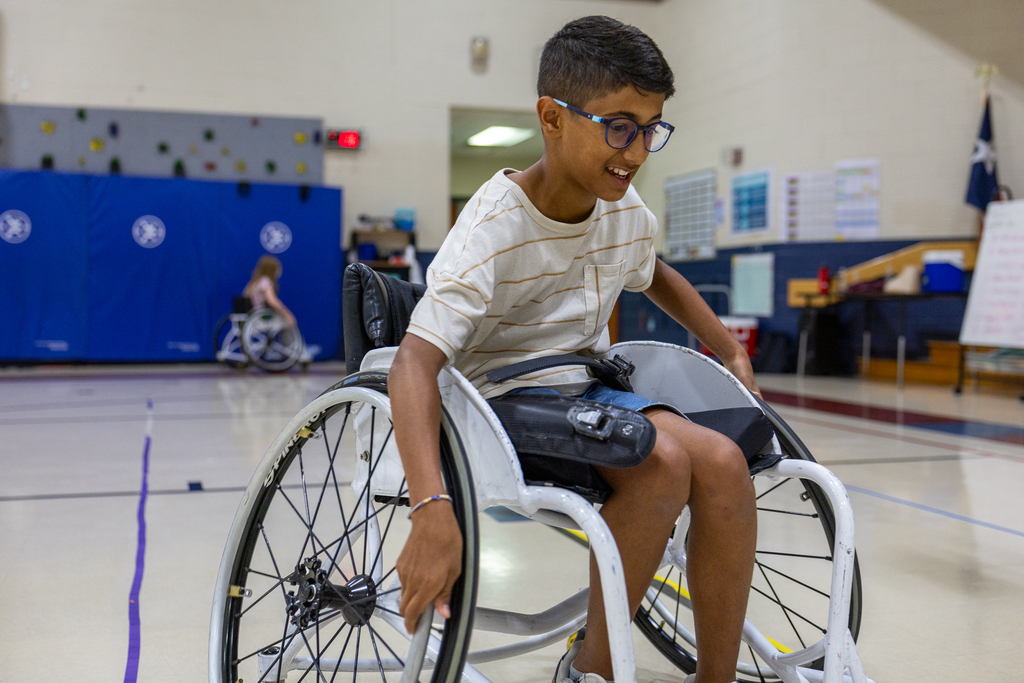 boy trying to operate a wheelchair