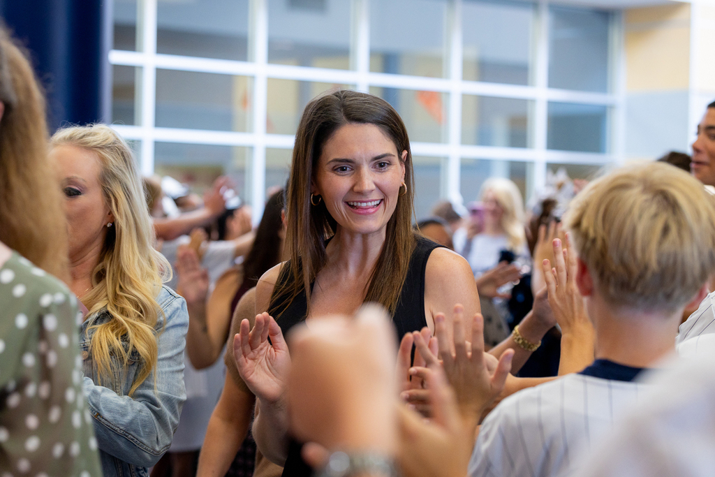 female participant smiling and high fiving PALS