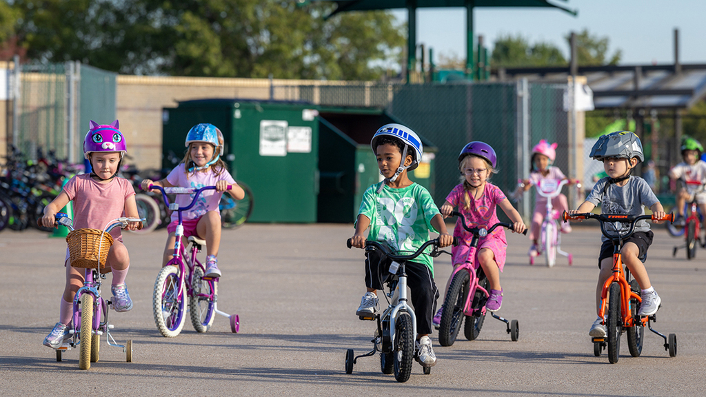 a group of kindergarten students riding together