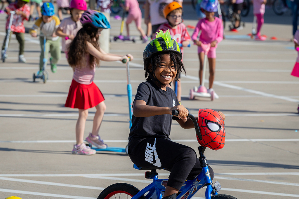 boy on bike smiling at camera