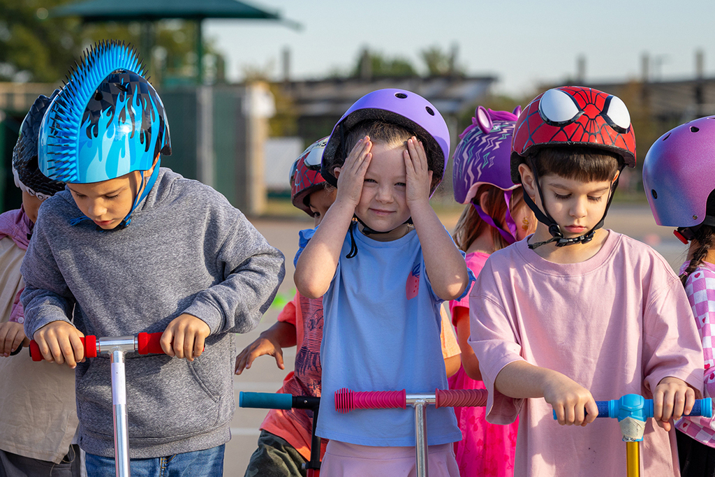 kids in a line with scooters waiting to start