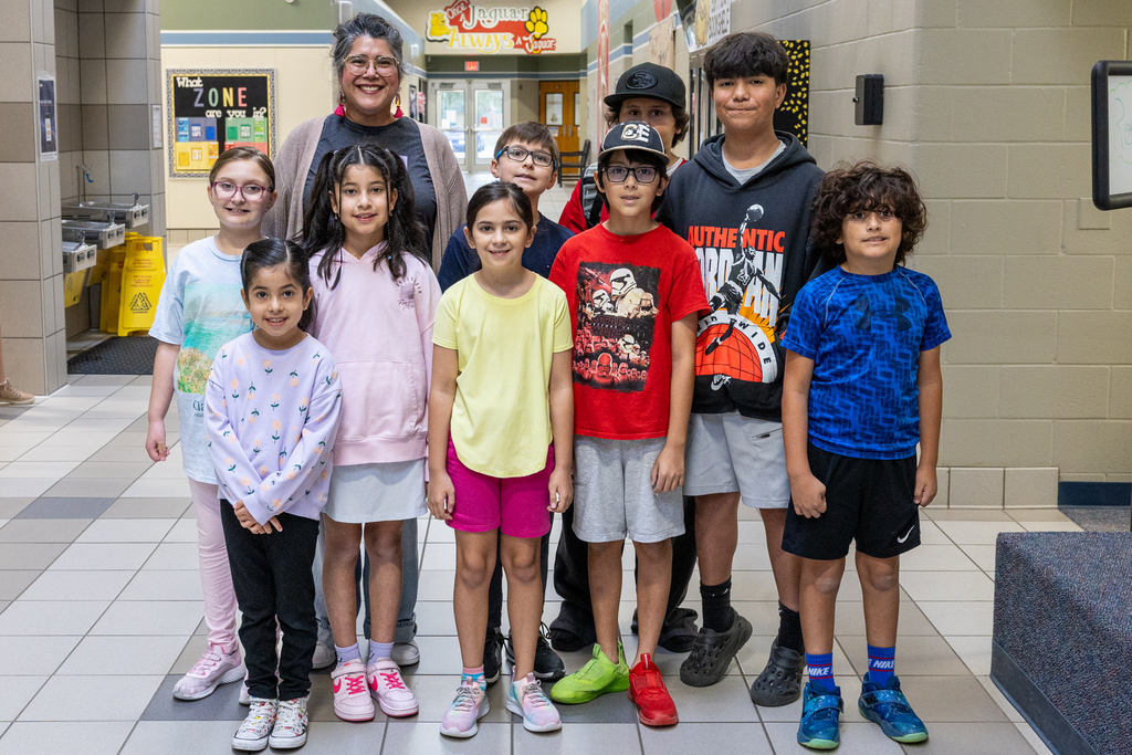 mrs. castro takes a photo with students