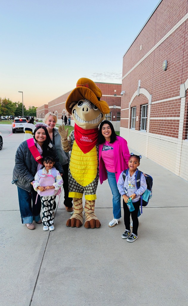 Andy the armadillo with staff and students