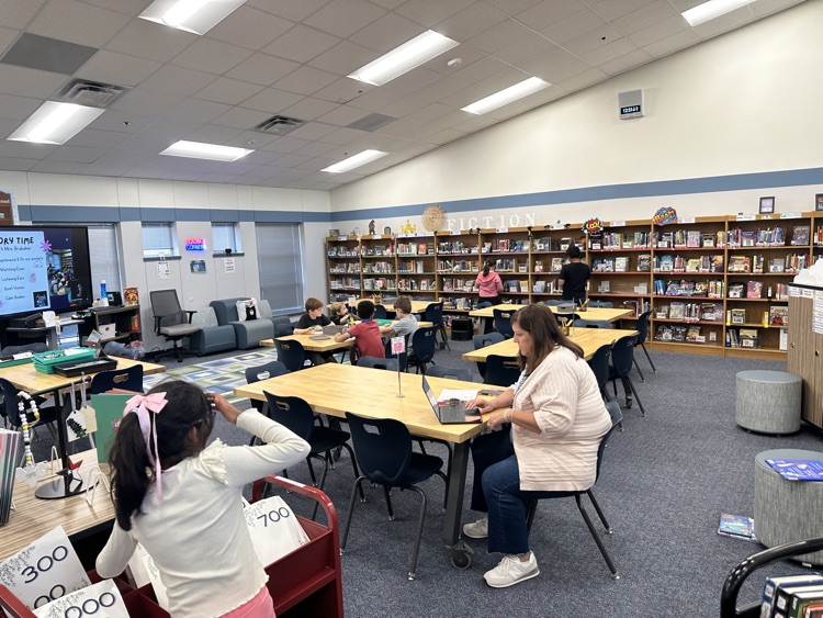 2nd graders checking out books