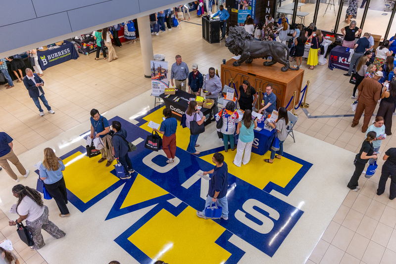 overhead view of teachers visiting booths at MHS concourse