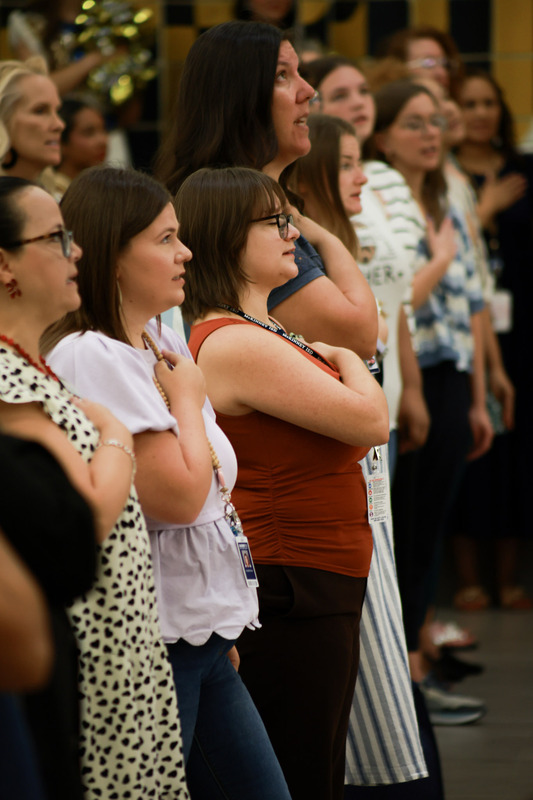 teachers with hands on heart for anthem
