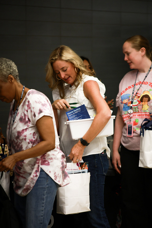 teachers in line with giveaways from booths
