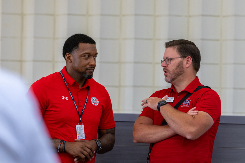 male principal talking with coach