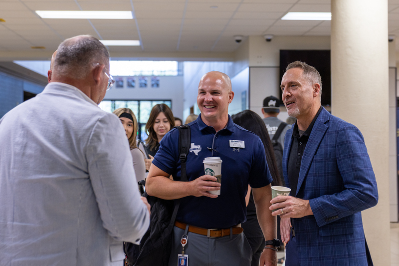 group of men talking and smiling