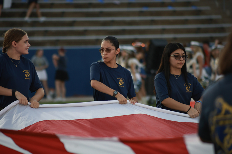 cadets holding large u.s. flag