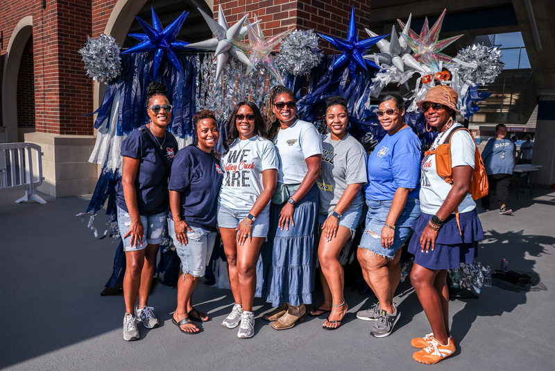 group of teachers and principals in front of backdrop