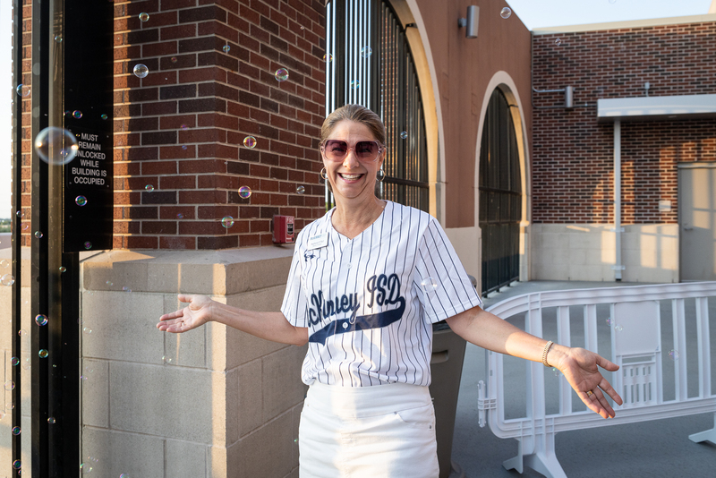 stephanie o'dell smiling at entrance with bubbles floating around