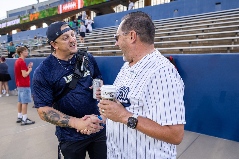 two men greeting one another with handshake