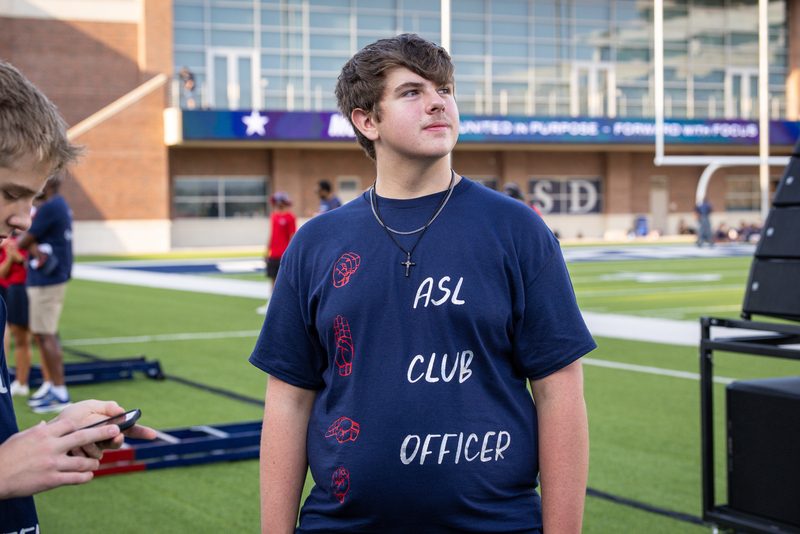 ASL club officer waiting to perform