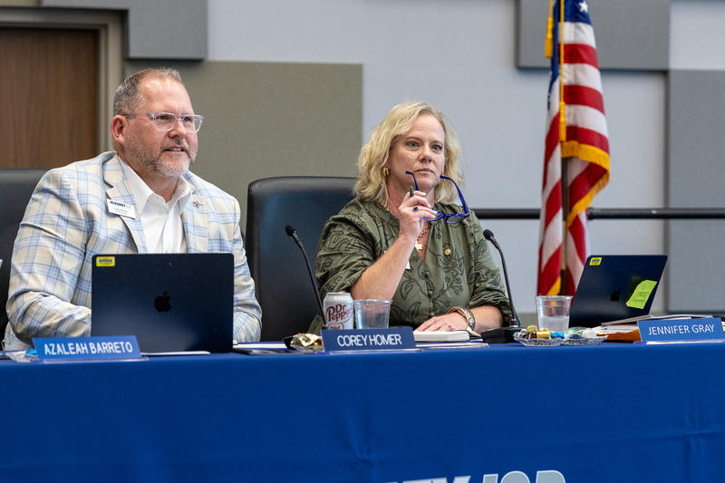 corey homer and jennifer gray at board places during the meeting