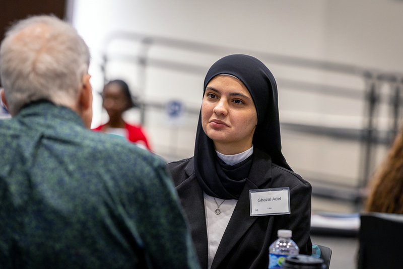 female student at table with interviewer