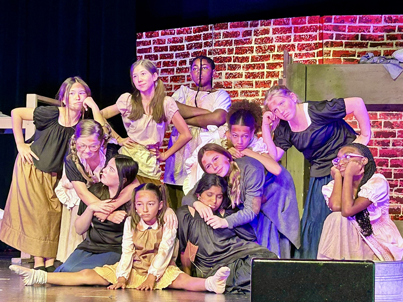 characters onstage performing a song