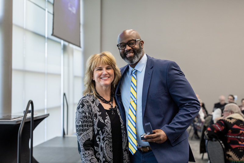 Holley and Jennifer Frazier smiling as he accepts his Hall of Honor ring
