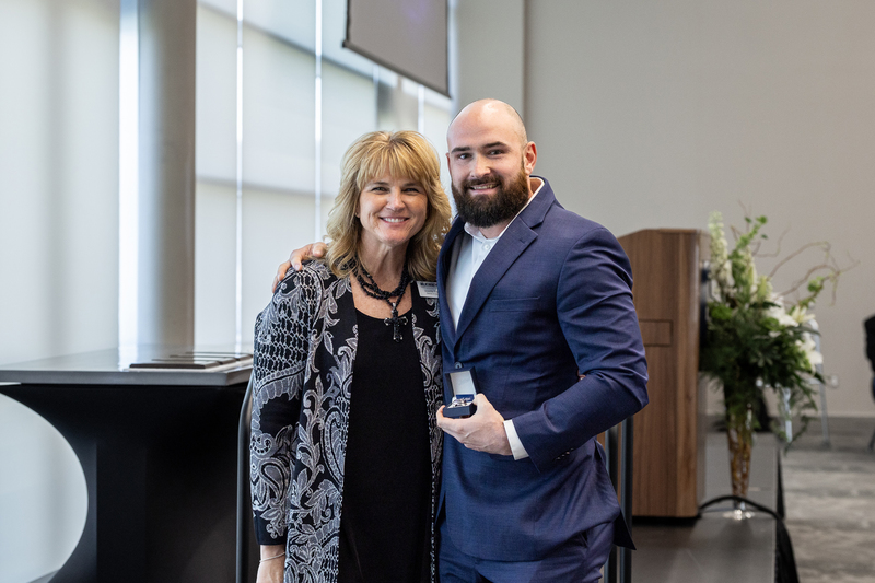 Lipka standing with Jennifer Frazier holding his Hall of Honor ring