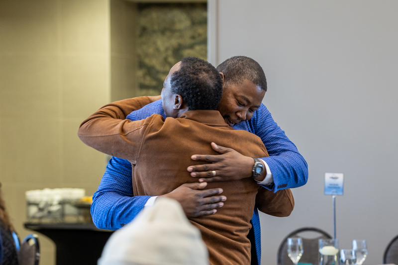 Donte Wilson greeting another man with a hug before the ceremony