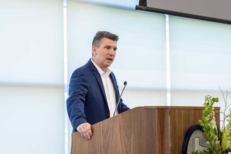 Coach Colby Peek at the podium speaking