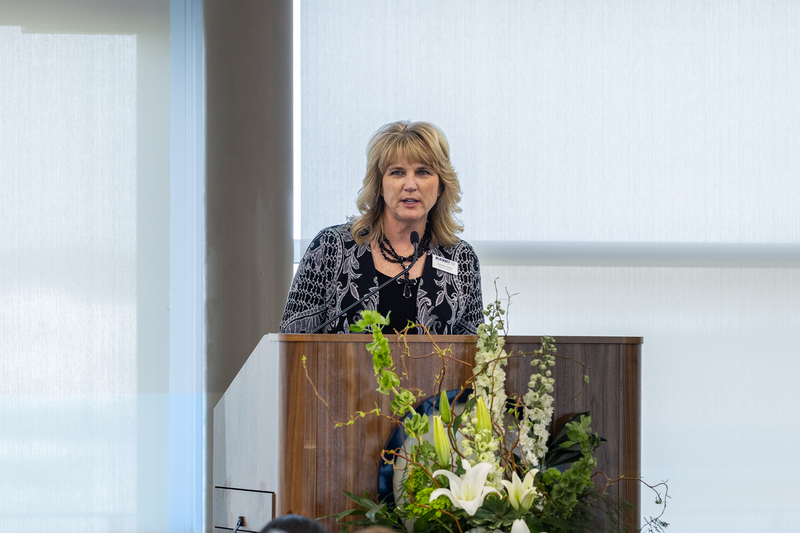 Athletics Director Jennifer Frazier at the podium speaking