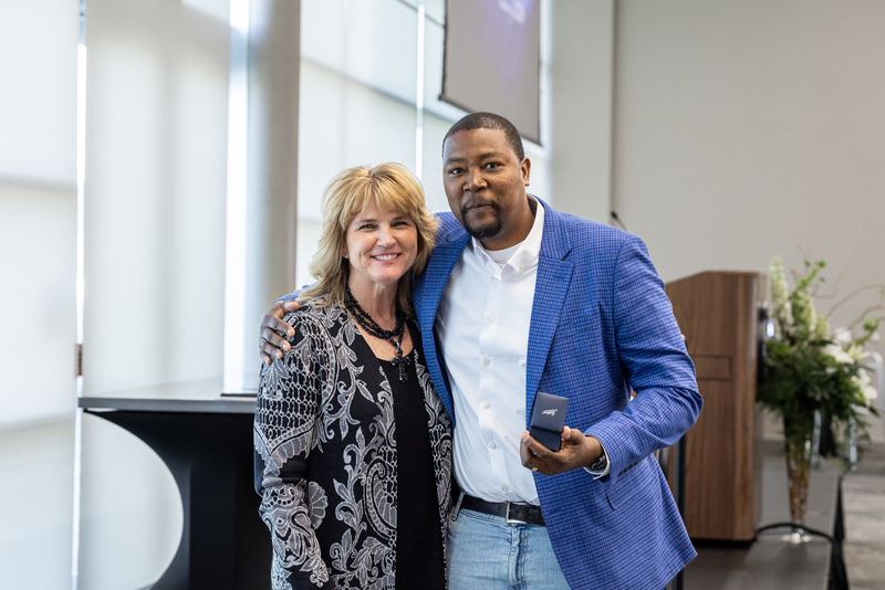 Donte Wilson standing with Frazier with his Hall of Honor ring
