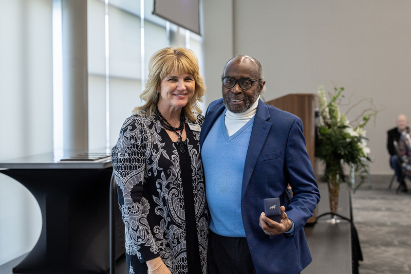 Otis Fields standing with Jennifer Frazier holding his Hall of Honor Ring