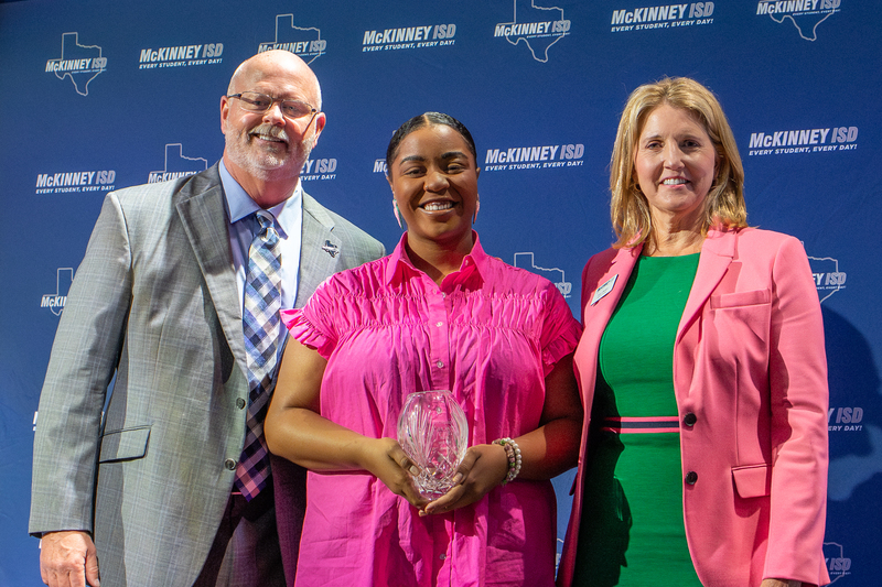 monroe onstage with award