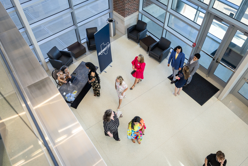 overhead of people walking in the foyer