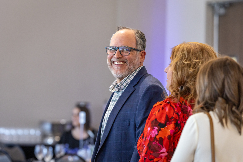 teacher smiling with other guests