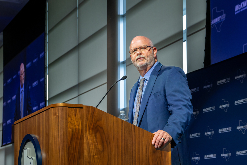 Pratt at the podium speaking