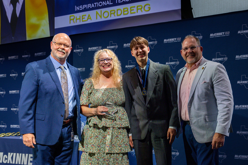 on stage with award