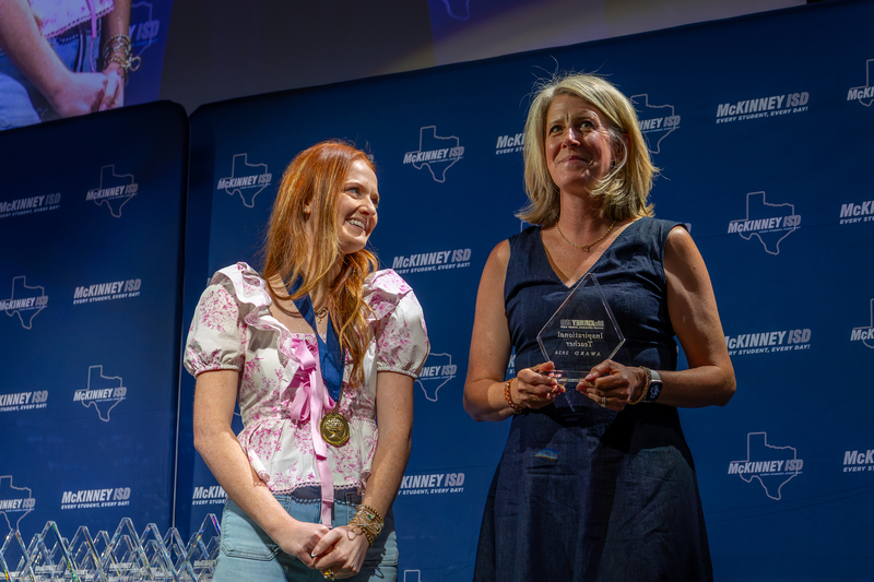 on stage with award