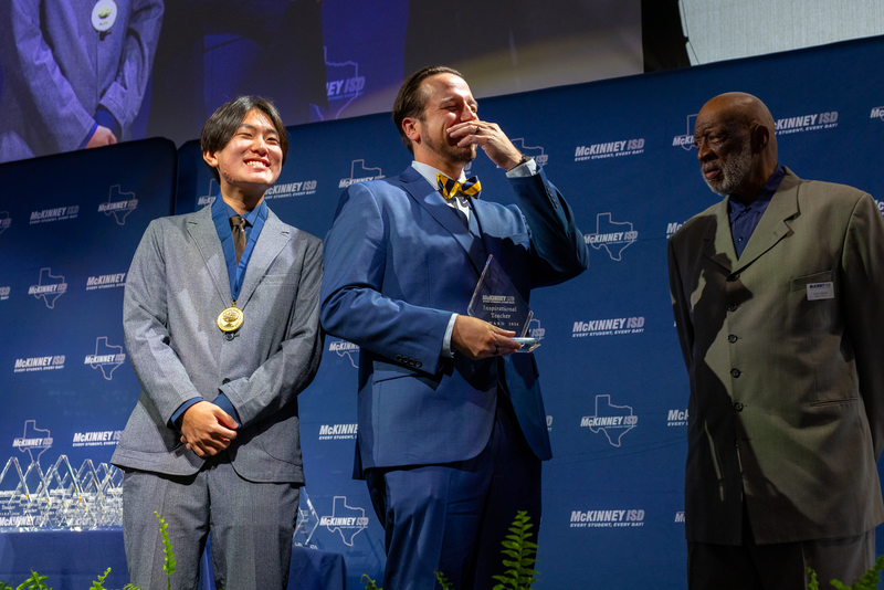 on stage with award