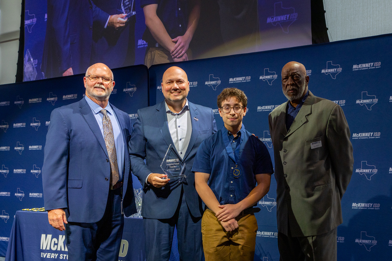 on stage with award
